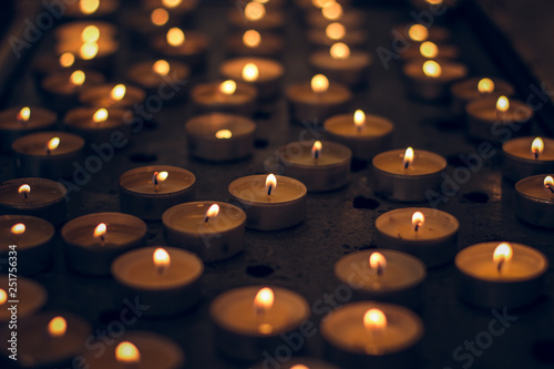 many candles soft yellow lights in darkness mystic atmosphere environment 
