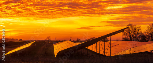 Solar power plant on the background of dramatic  fiery sky at sunset Germany