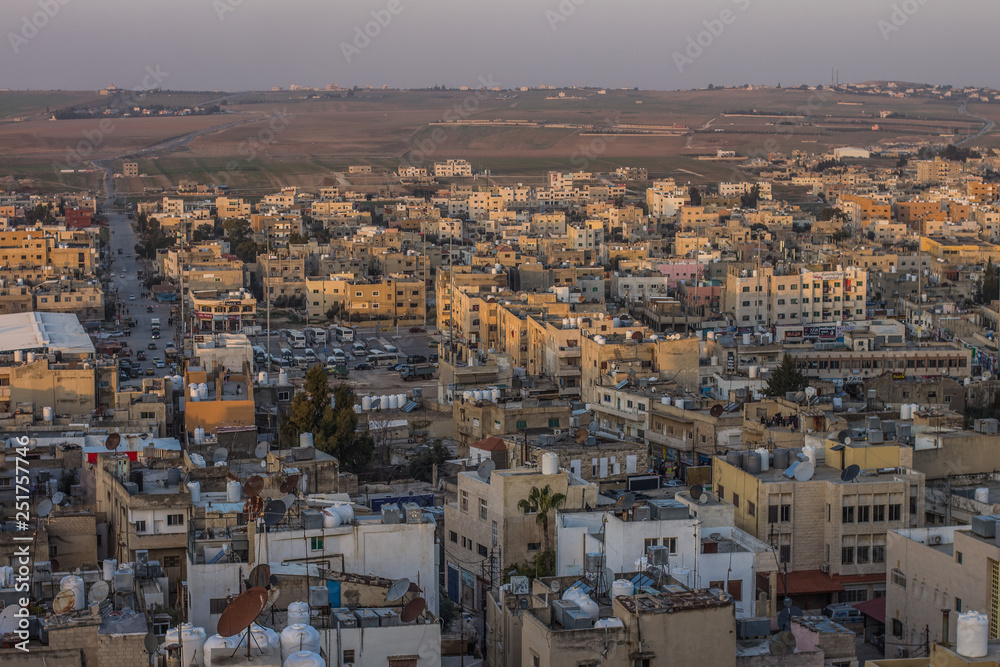 aerial photography of Arabic poor third world city in Middle East part of Earth in evening sunset time with soft colors and small stone buildings   