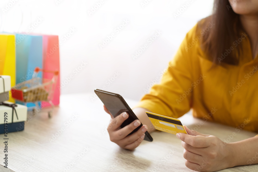 Fototapeta premium woman using credit card shopping online with mobile smartphone