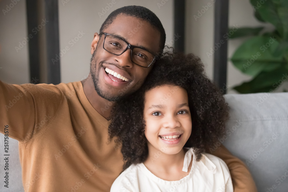 Smiling black father and child taking selfie looking at camera Smiling black father and child taking selfie looking at camera
