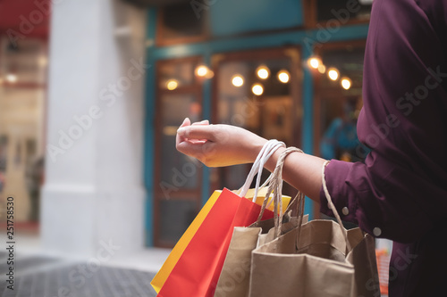 woman with shopping bags at outdoor market mall