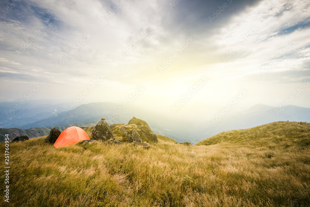 Group of hikers walking on a mountain at sunset. young man Asia tourist at mountain is watching over the misty and foggy morning sunrise, travel Trekking Group of hikers walking on a mountain at sunset. young man Asia tourist at mountain is watching over the misty and foggy morning sunrise, travel Trekking