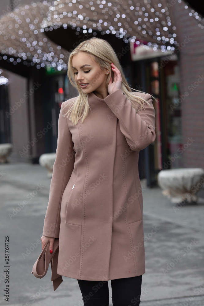 young stylish beautiful woman walking in street, wearing coat , fashion outfit, autumn trend. young stylish beautiful woman walking in street, wearing coat , fashion outfit, autumn trend.