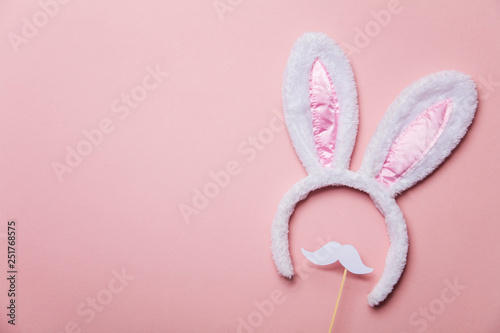Easter bunny ears with white moustache on a pastel pink background