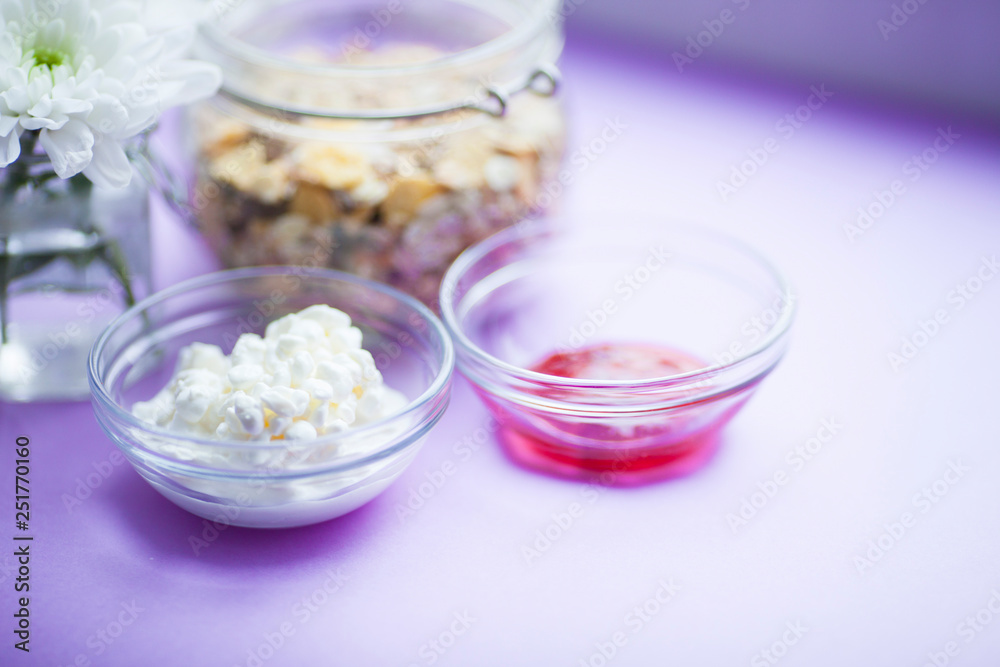 Healthy food concept. Muesli, fruits, curd and jam for productive day on the purple background. Top view. Space for a text. Healthy food concept. Muesli, fruits, curd and jam for productive day on the purple background. Top view. Space for a text.