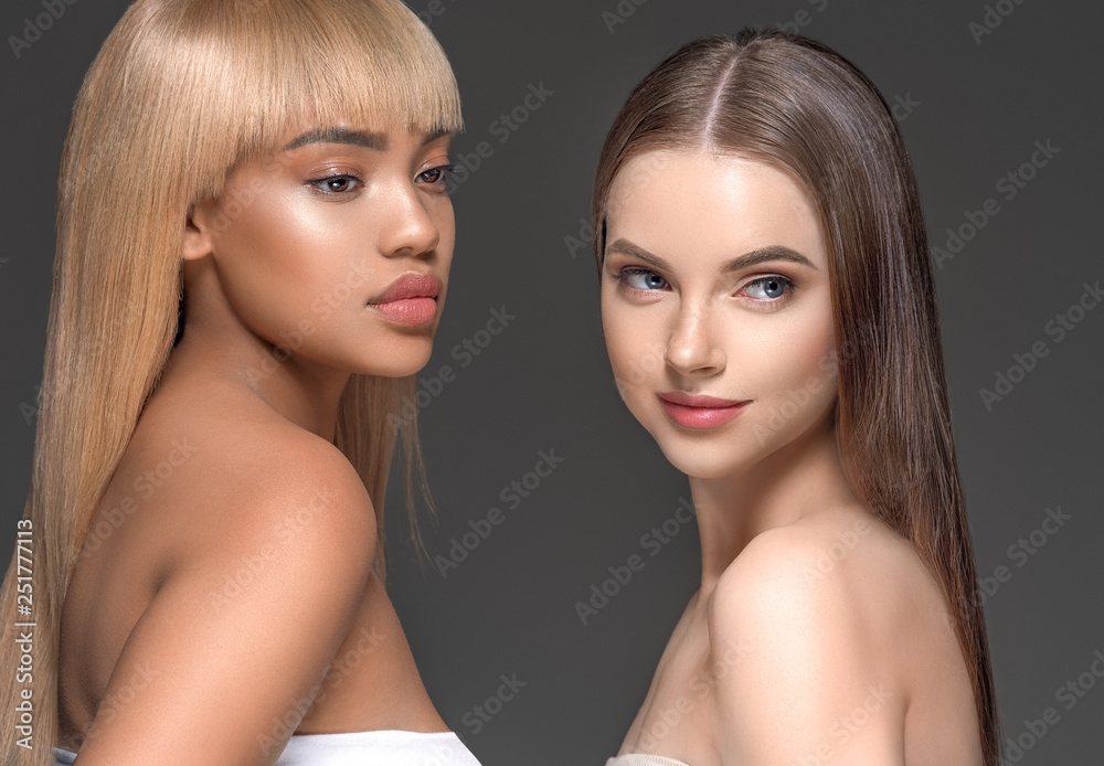 Two wemen with dark and light skin tone caucasian and african american models with different skintones lines beauty healthy concept Two wemen with dark and light skin tone caucasian and african american models with different skintones lines beauty healthy concept