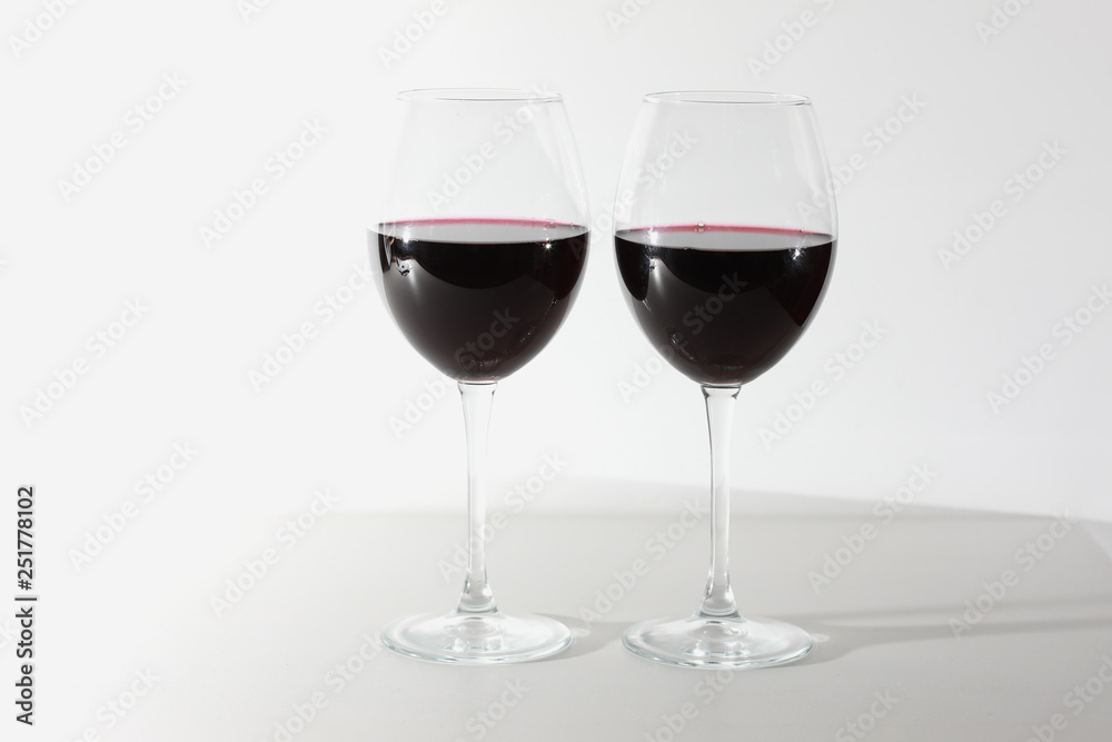 Glass of red wine isolated on white background. A glass of red wine. Copy space. Concept restaurant, alcohol, party. Glass of red wine isolated on white background. A glass of red wine. Copy space. Concept restaurant, alcohol, party.