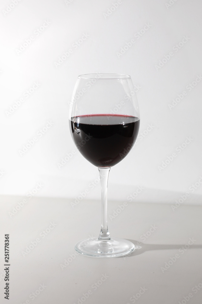 Glass of red wine isolated on white background. A glass of red wine. Copy space. Concept restaurant, alcohol, party. Glass of red wine isolated on white background. A glass of red wine. Copy space. Concept restaurant, alcohol, party.