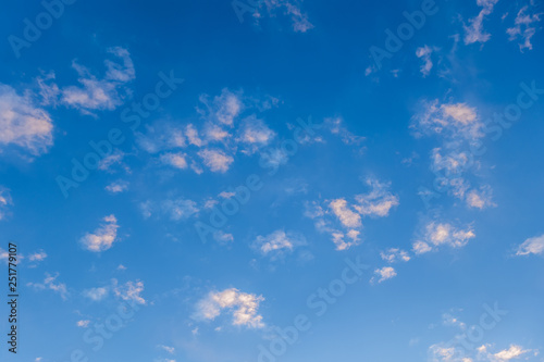 light fluffy clouds on a bright blue sky