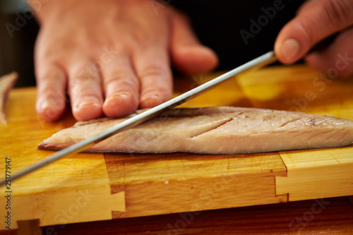 Slicing fish with knife