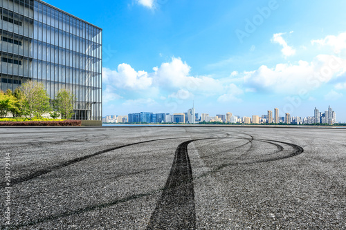 Empty asphalt square ground and city skyline with buildings in Hangzhou