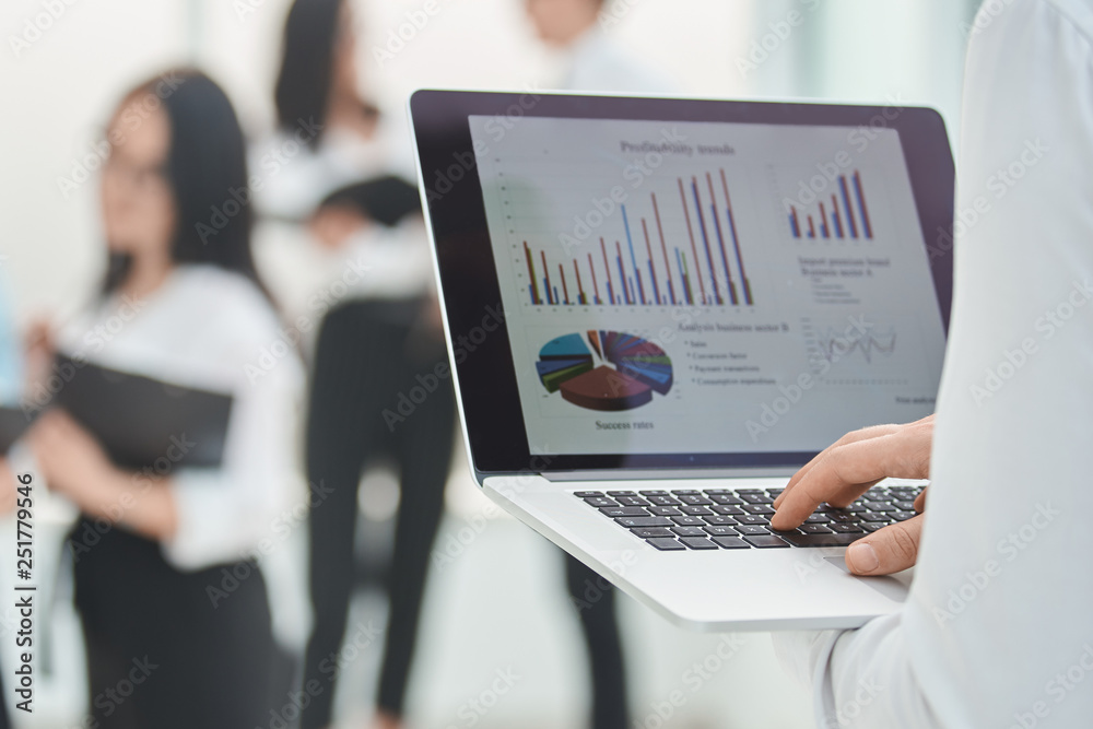 close up. the businessman uses a laptop to analyze financial data