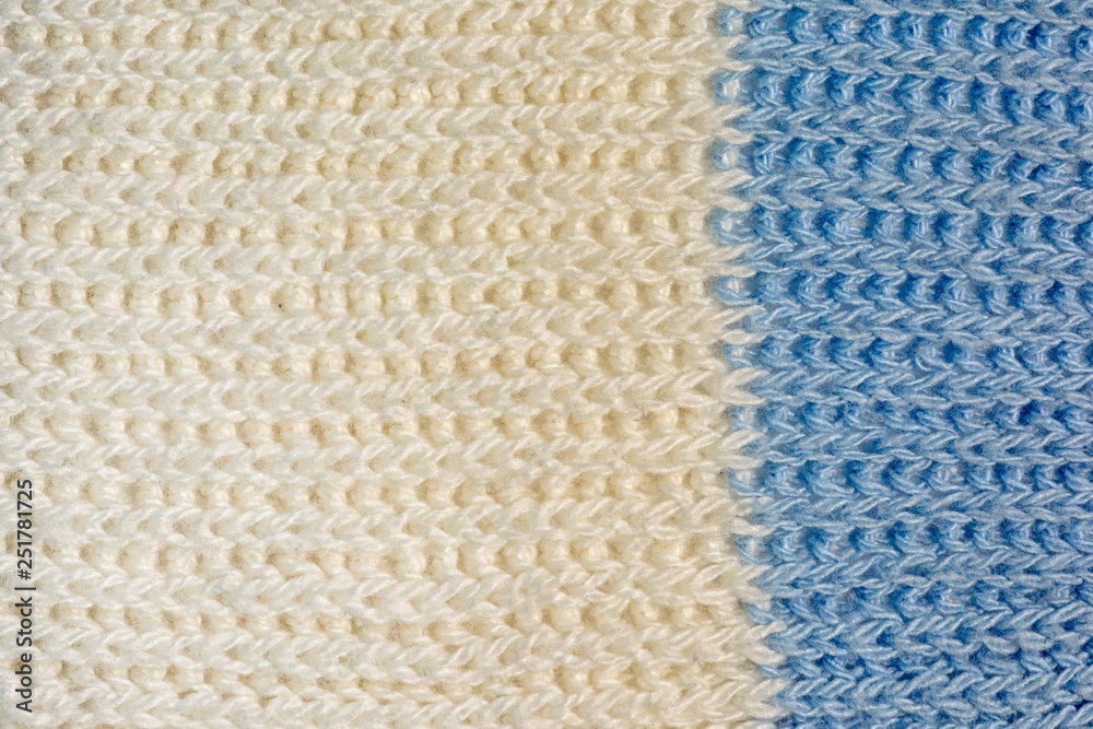 Texture, two-color knitted jersey close-up. Blank white-blue wool background. Texture, two-color knitted jersey close-up. Blank white-blue wool background.