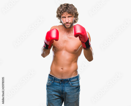 Handsome hispanic boxer man wearing boxing gloves over isolated background skeptic and nervous, frowning upset because of problem. Negative person. © Krakenimages.com