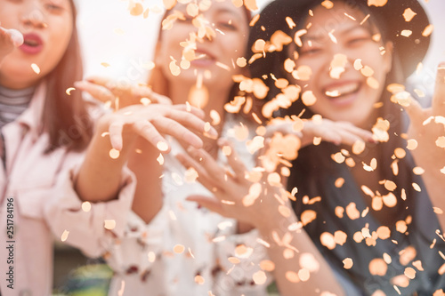 Photography Blurred asian friends having fun throwing confetti at party outdoor - Young tren