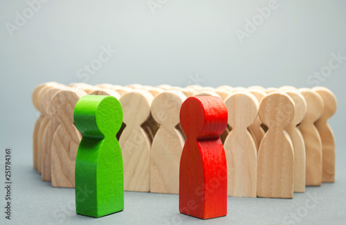 Red and green people stand in front of a crowd. Two opponents. Conflict of interest. Dispute. Search for compromises. Social problems. Business competition. Candidates Political Debate