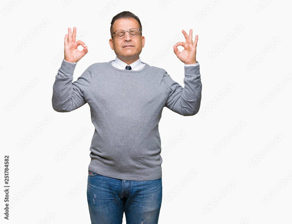 Middle age bussines arab man wearing glasses over isolated background relax and smiling with eyes closed doing meditation gesture with fingers. Yoga concept. Middle age bussines arab man wearing glasses over isolated background relax and smiling with eyes closed doing meditation gesture with fingers. Yoga concept.