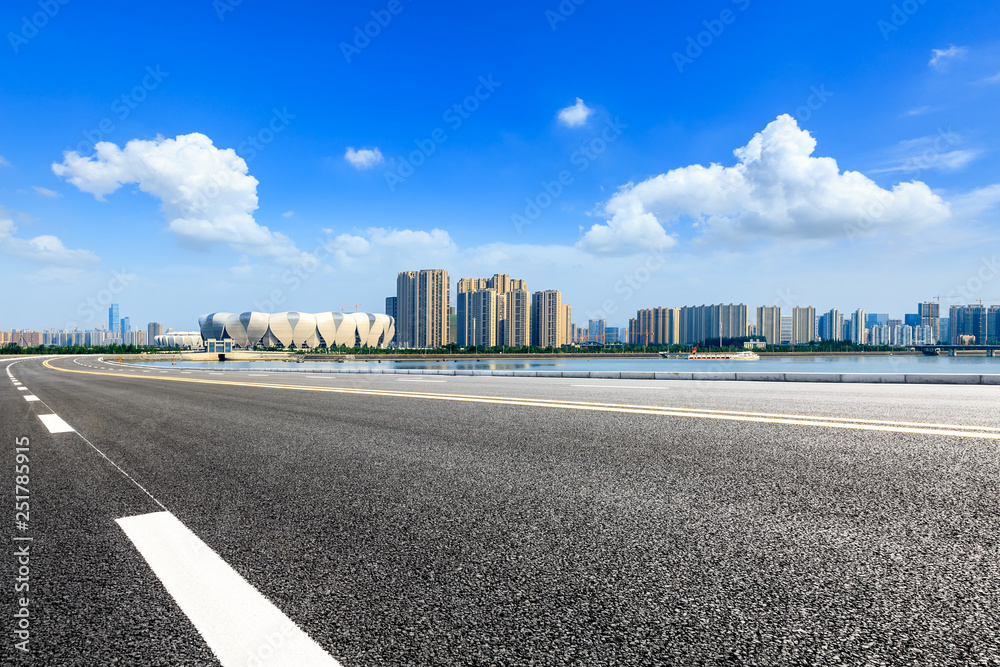 Fototapeta premium Empty asphalt road and modern city skyline with buildings in Hangzhou