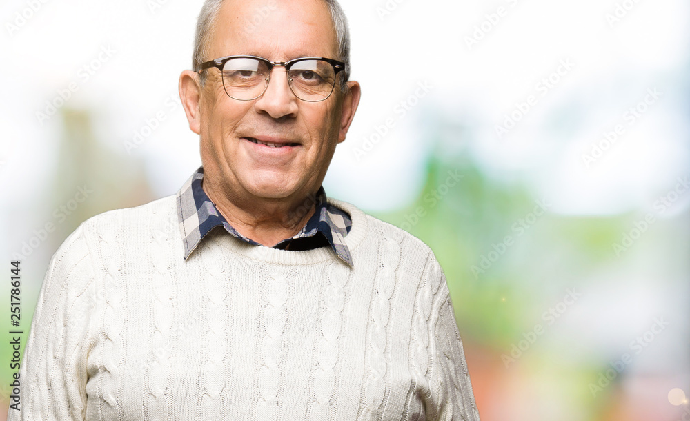 Handsome senior man wearing glasses and winter sweater with a happy and cool smile on face. Lucky person. Handsome senior man wearing glasses and winter sweater with a happy and cool smile on face. Lucky person.