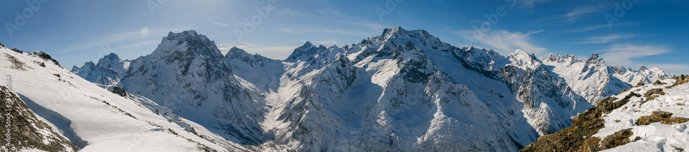 Panoramic view of snow covered Caucasus mountains, Dombai, Karachai-Cherkess, Russia.