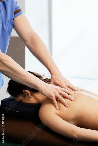 Physiotherapist giving backstroke therapy to a woman