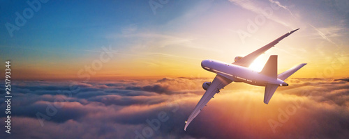 Passengers commercial airplane flying above clouds © Jag_cz