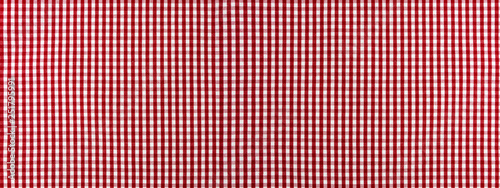 Red and white checkered classic tablecloth fabric closeup, clean background.
