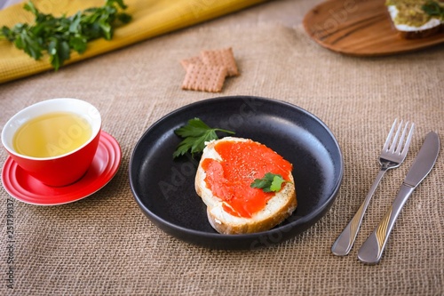 Breackfast toasts with salmon and a cup of green tea..