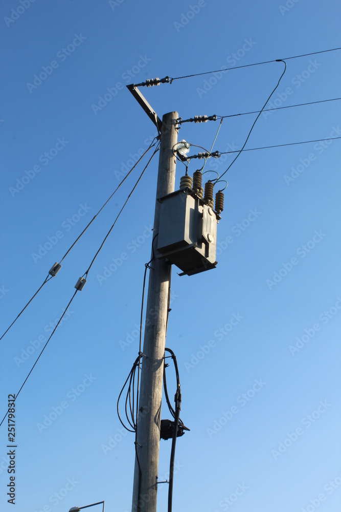 Low Angle View Of Electricity Pylon Against Clear Blue Sky Low Angle View Of Electricity Pylon Against Clear Blue Sky