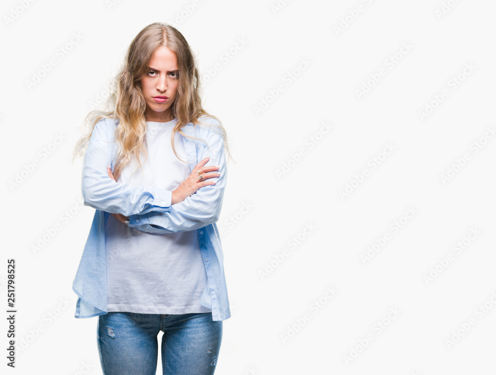 Beautiful young blonde woman over isolated background skeptic and nervous, disapproving expression on face with crossed arms. Negative person. Beautiful young blonde woman over isolated background skeptic and nervous, disapproving expression on face with crossed arms. Negative person.
