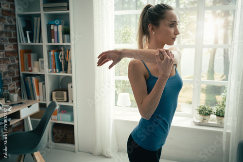 Woman doing stretching exercises at home
