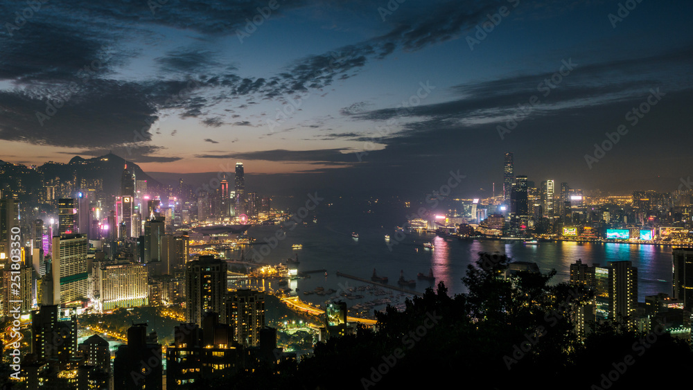 Hong Kong skyline at twilight. High view overlooking Victoria Harbor including both Hong Kong island and Kowloon