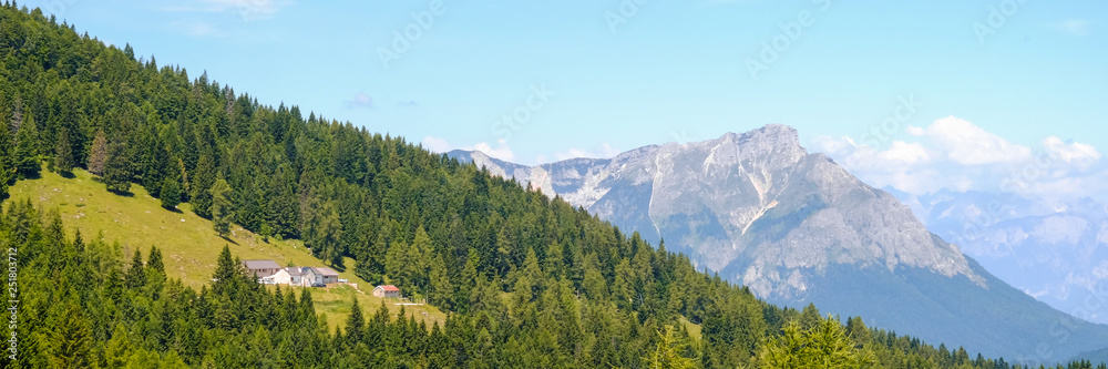 Panorama and landscape from the top of a mountain pass in the italian Alps during a trekking day. Passo Coe, Folgaria, Trento, Trentino alto Adige, Italy. 8th july 2018