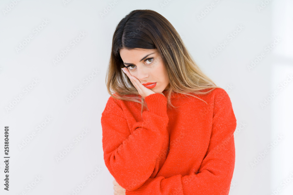 Young woman wearing casual red sweater over isolated background thinking looking tired and bored with depression problems with crossed arms. Young woman wearing casual red sweater over isolated background thinking looking tired and bored with depression problems with crossed arms.