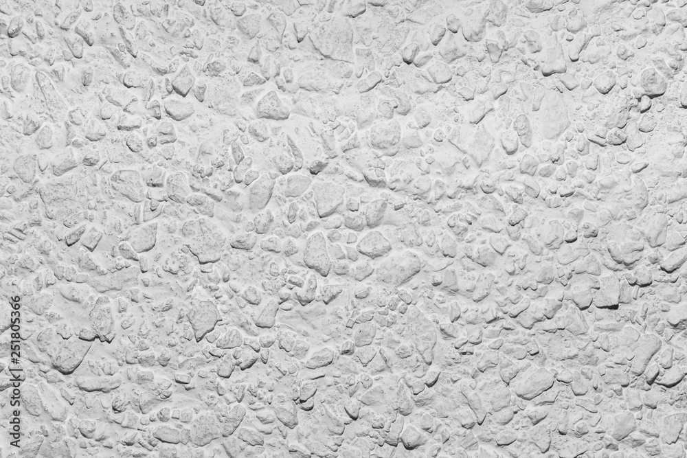 Black and white whitewashed concrete wall interspersed with stones Black and white whitewashed concrete wall interspersed with stones
