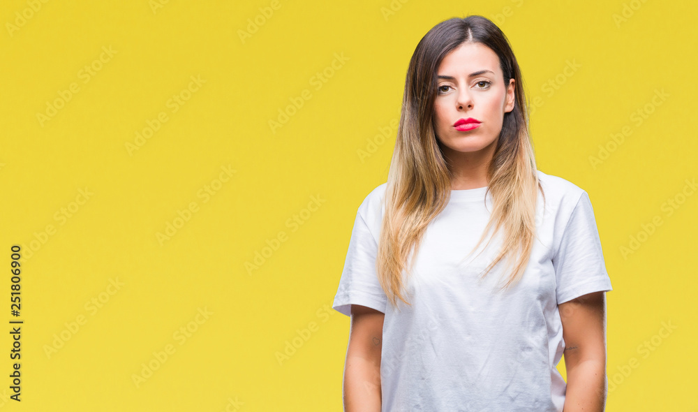 Young beautiful woman casual white t-shirt over isolated background with serious expression on face. Simple and natural looking at the camera. Young beautiful woman casual white t-shirt over isolated background with serious expression on face. Simple and natural looking at the camera.