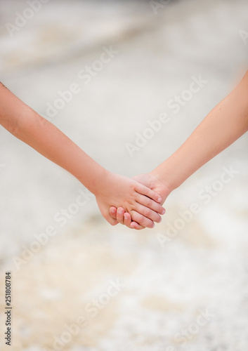 two little children holding hands. the concept of friendship and love. helping children and others
