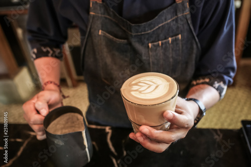 Professional barista making caffe latte or cappuccino. Latte art.