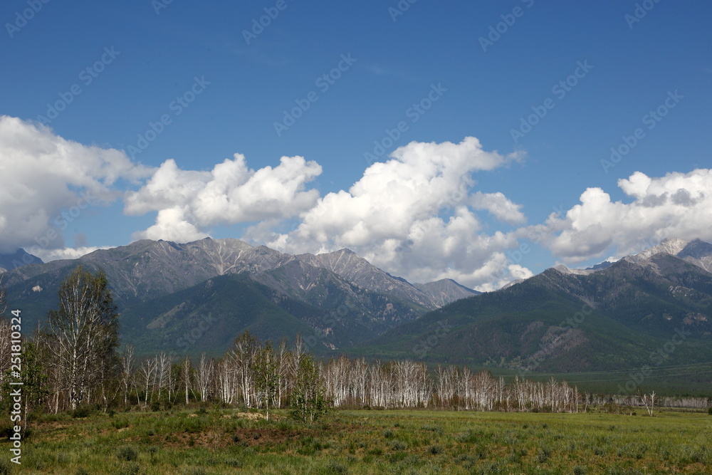 Fototapeta The mountains of the Barguzin mountains, this valley of the Barguzin river Steppe in the floodplain of the Barguzin river, then-birch forest belt, and behind it-the mountains of Barguzin ridge and the
