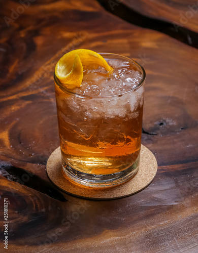 A whiskey based cocktail, mixed with house-made bitters and an orange peel. photo