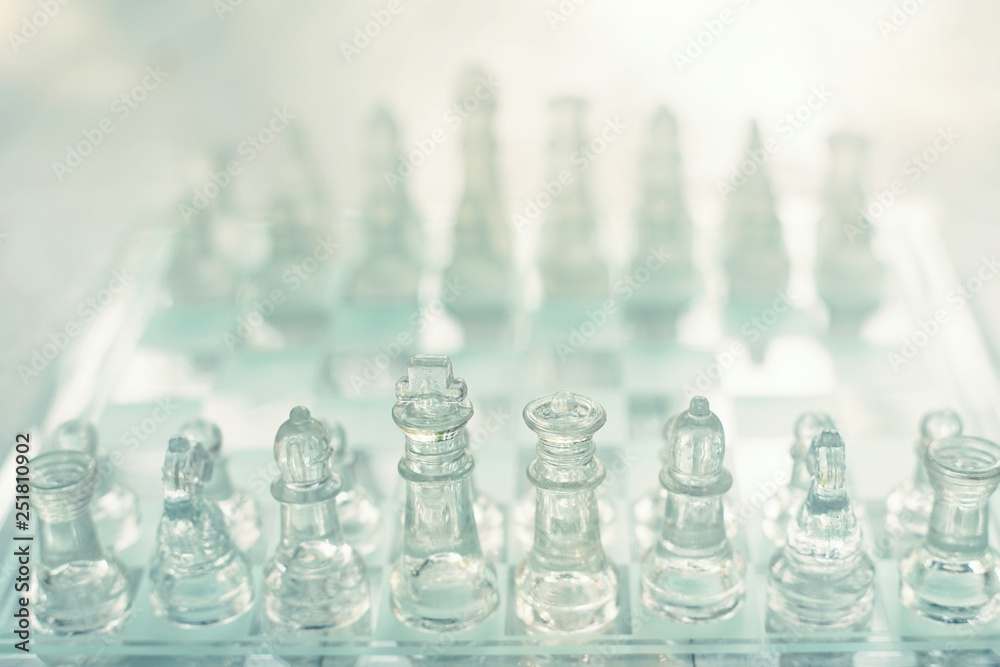 Chess board game made of glass, business competitive concept Chess board game made of glass, business competitive concept