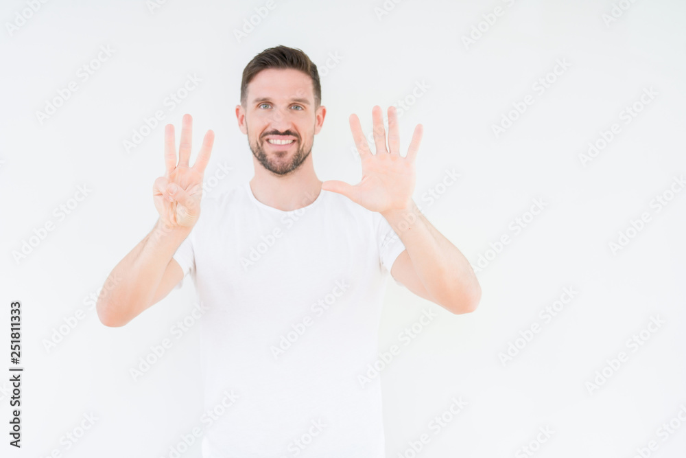 Young handsome man wearing casual white t-shirt over isolated background showing and pointing up with fingers number eight while smiling confident and happy. Young handsome man wearing casual white t-shirt over isolated background showing and pointing up with fingers number eight while smiling confident and happy.