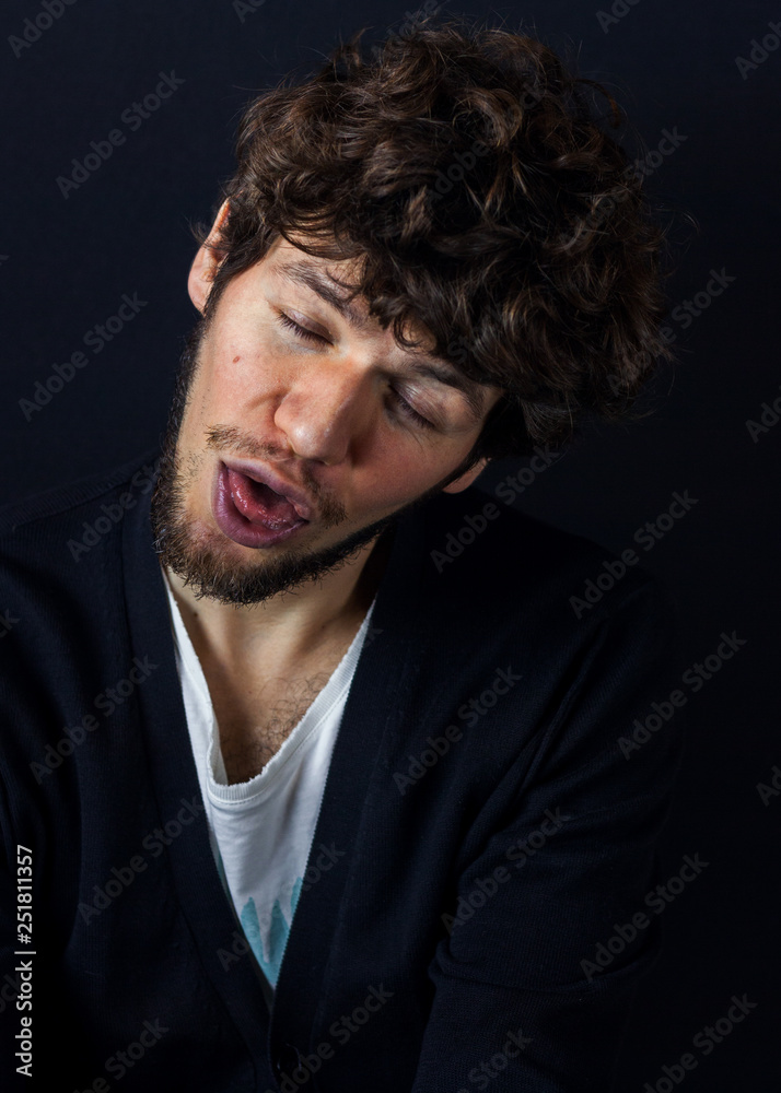 Fototapeta premium Curly man portrait on dark studio background