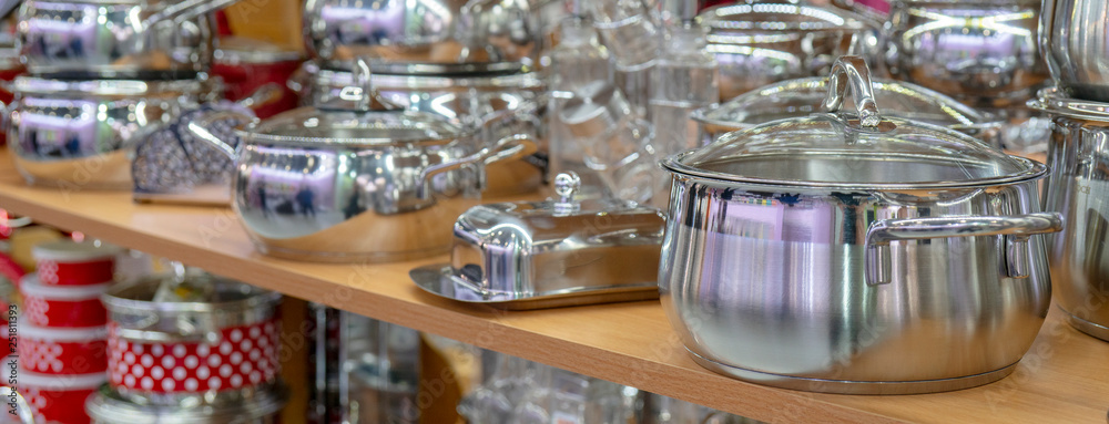 Stainless steel pans on the store shelf.