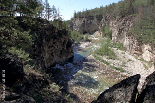 Mountain stream Alla deep in the valley of the mountains of the Barguzin range on a summer day