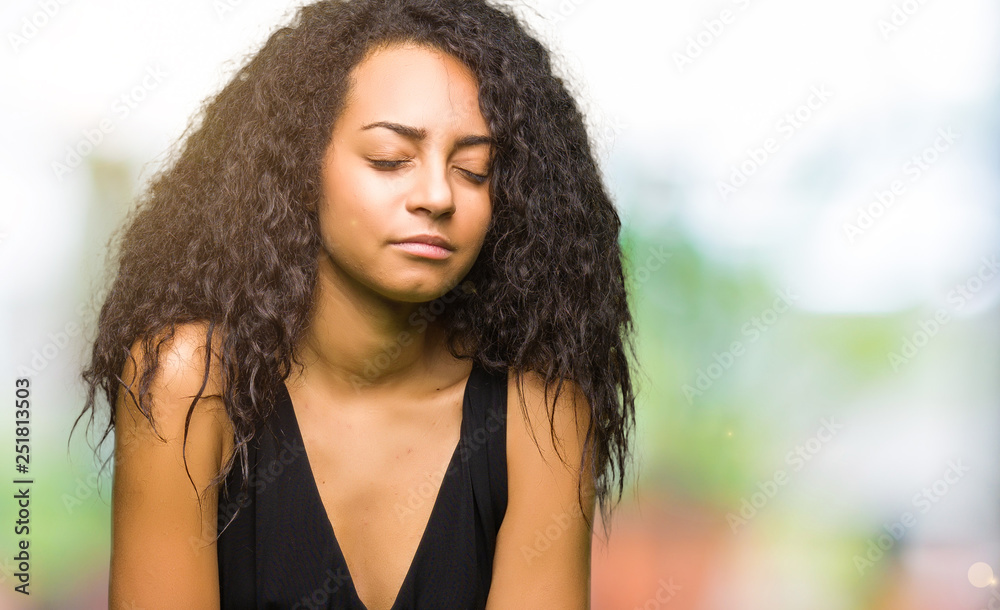 Young beautiful girl with curly hair wearing fashion skirt with hand on stomach because indigestion, painful illness feeling unwell. Ache concept.