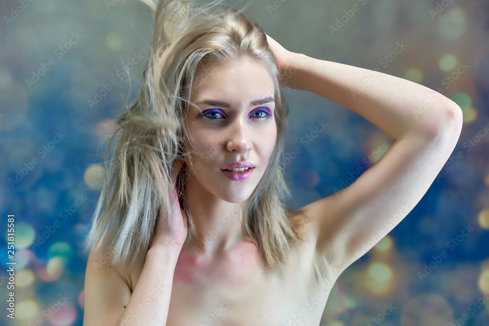 Close-up portrait concept of a beautiful blonde girl on a multi-colored background. Hair develops in different directions. Close-up portrait concept of a beautiful blonde girl on a multi-colored background. Hair develops in different directions.