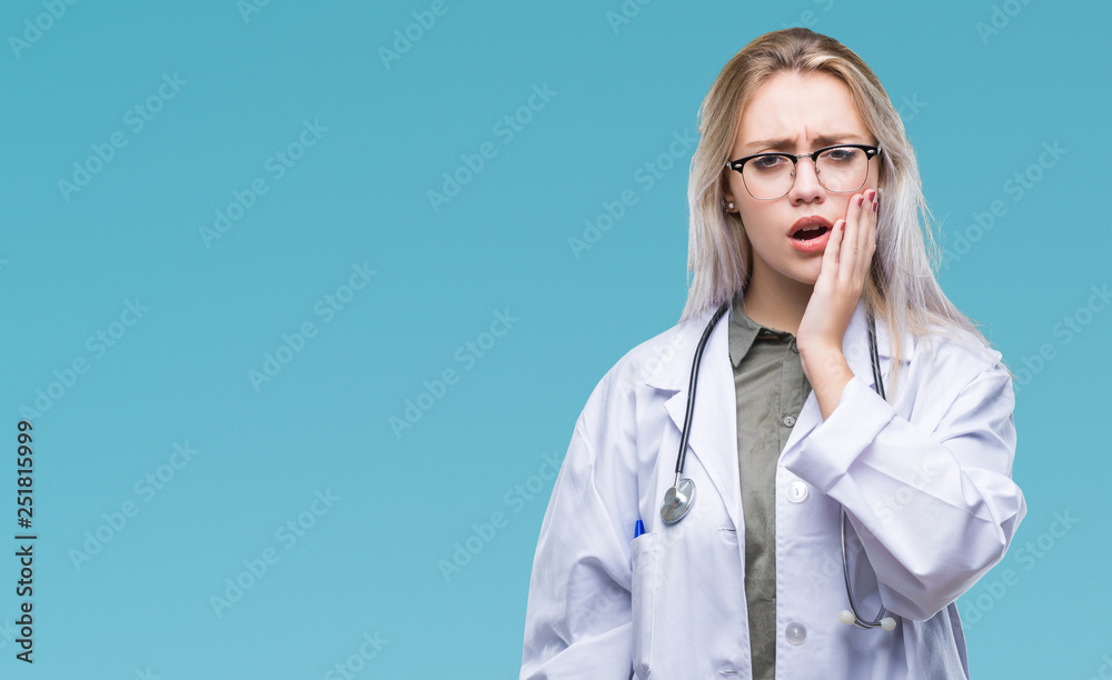 Young blonde doctor woman over isolated background touching mouth with hand with painful expression because of toothache or dental illness on teeth. Dentist concept. Young blonde doctor woman over isolated background touching mouth with hand with painful expression because of toothache or dental illness on teeth. Dentist concept.