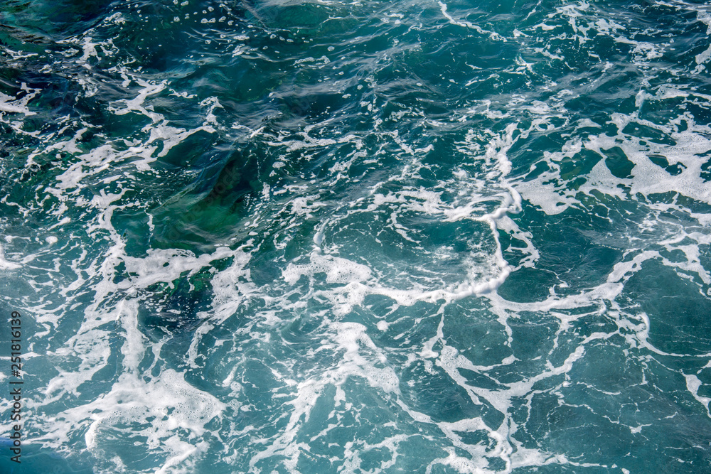 Blue sea water with white foam Blue sea water with white foam